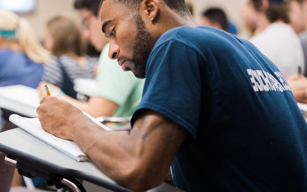 Student at a desk taking notes